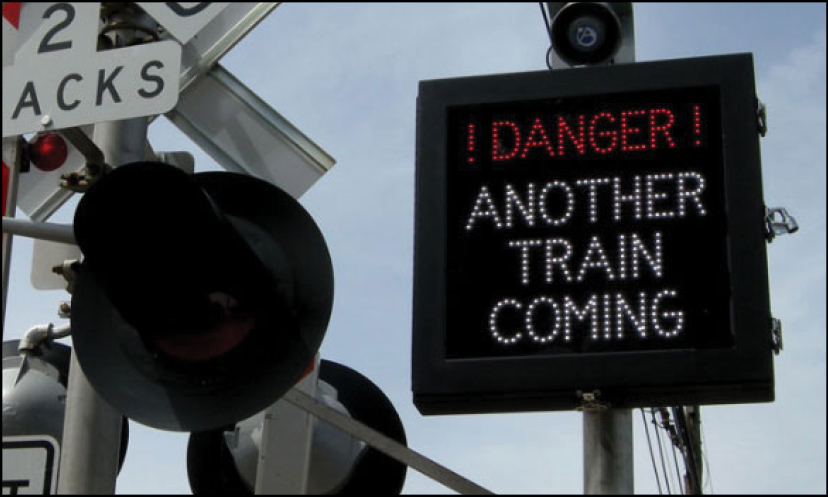 An electronic sign indicating an approaching train